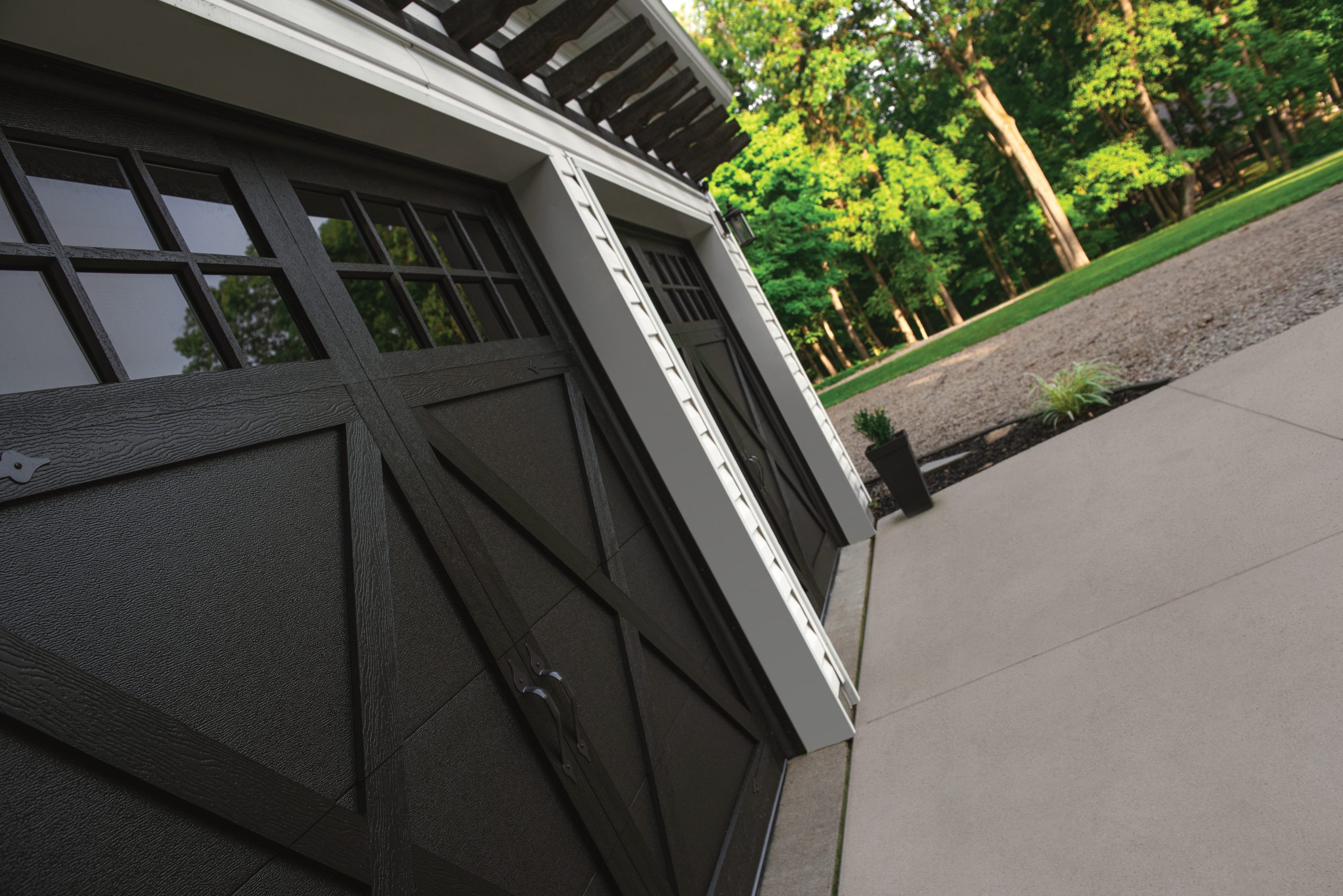 Garage door featuring steel overlay panels