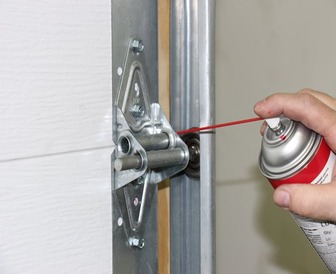 Lubricating the door hinges, a common cause of noisy doors.