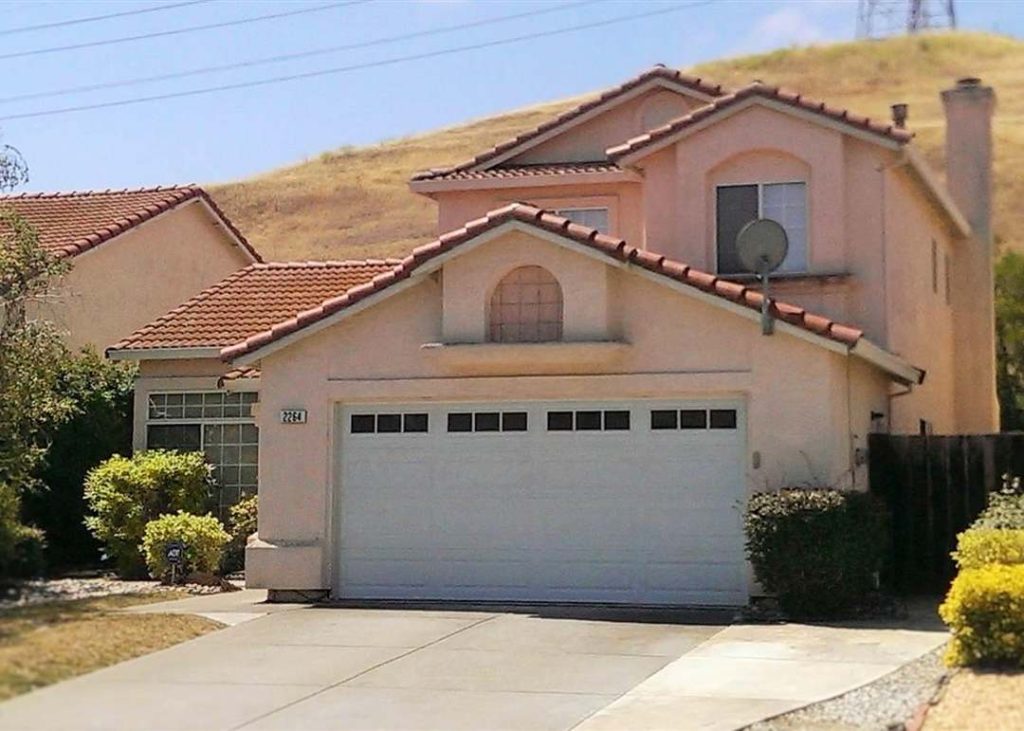 Pittsburg CA house with front-facing garage and landscaped yard