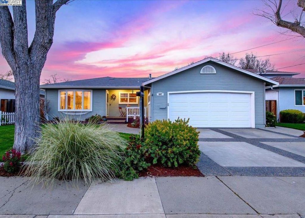 Suburban single-family house in Pleasanton, California showing attached garage door and driveway