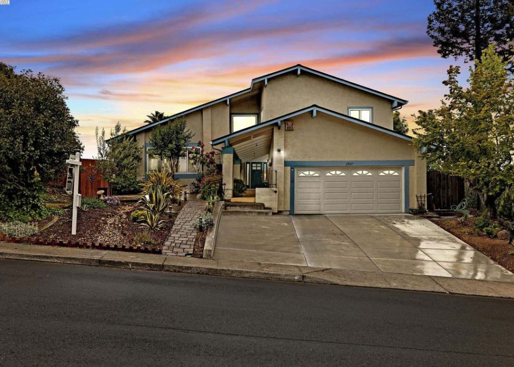 Front exterior of a Hayward-style suburban house showing a closed double garage door and driveway.